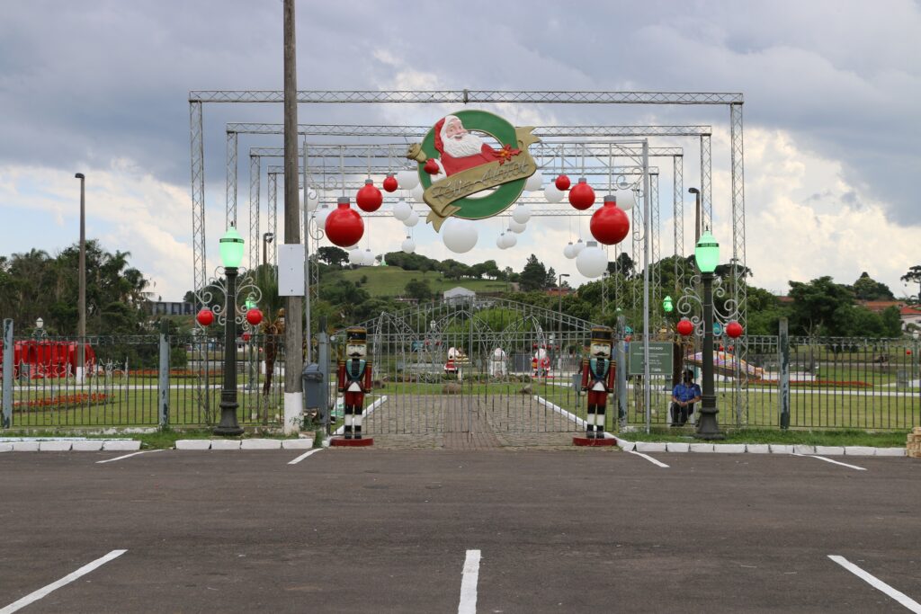 Foto dos portões de entrada do Parque Lacustre de Castro, decorado com Papai Noel, Quebra-nozes e bolas natalinas