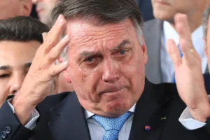 Jair Bolsonaro levantando as mãos, expressando indignação