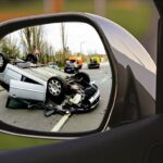 foto de um espelho de retrovisor em momento de acidente de carro