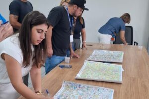 Comissão julgadora avaliando mapas dos participantes do Vamos Pintar Carambeí