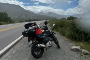 Motocicletas paradas à beira da rodovia na Argentina, tendo ao fundo a imagem de montanhas