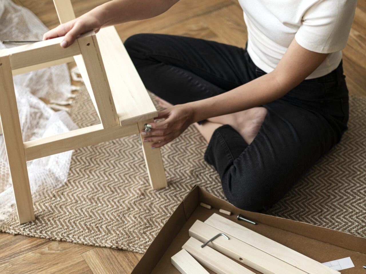 Woman assembling a diy chair from scratch